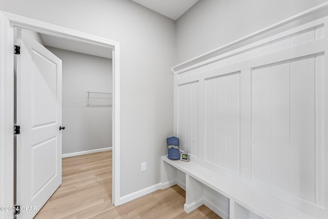 mudroom with baseboards and light wood-style floors