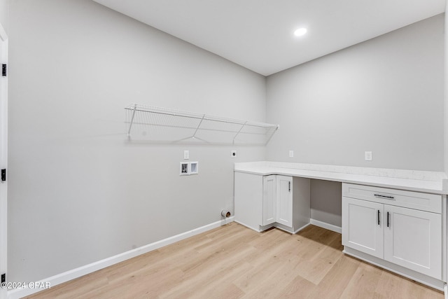 laundry room with hookup for a washing machine, electric dryer hookup, light wood-type flooring, and baseboards