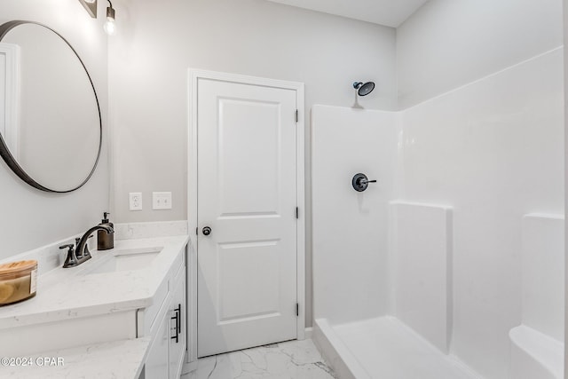 full bathroom with vanity, marble finish floor, and walk in shower