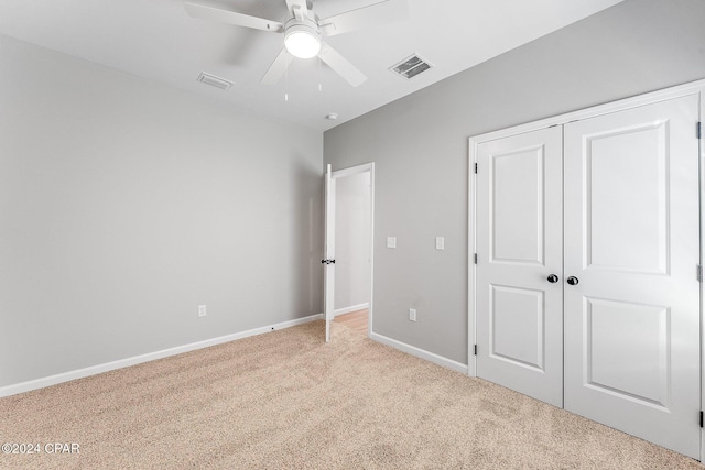 unfurnished bedroom with a closet, baseboards, visible vents, and carpet floors