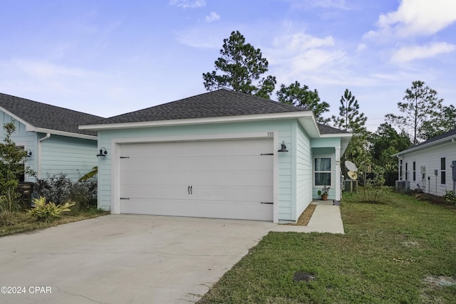 view of front of house with central AC, a garage, and a front lawn