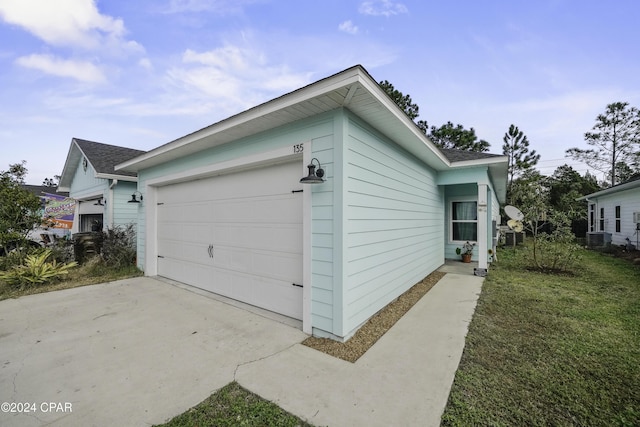 exterior space featuring central air condition unit and a yard