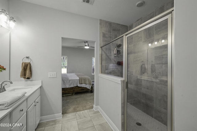 bathroom featuring tile patterned flooring, vanity, ceiling fan, and a shower with shower door