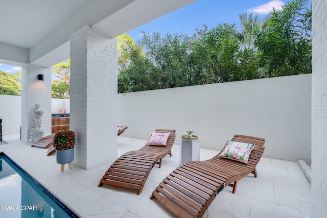 view of patio / terrace with a fenced in pool