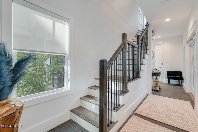 stairway with tile patterned flooring