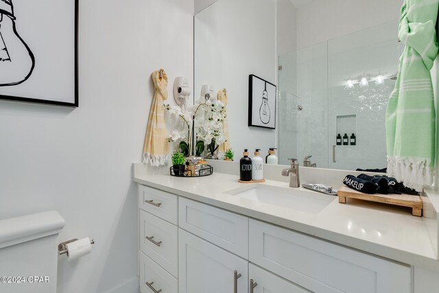 bathroom with vanity, toilet, and walk in shower