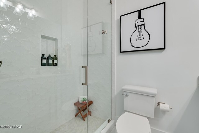 bathroom featuring toilet and a shower