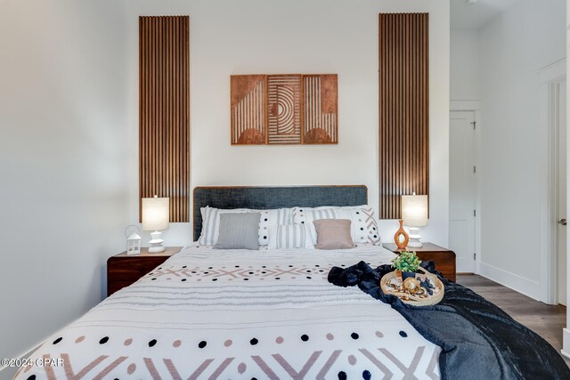 bedroom with dark hardwood / wood-style flooring