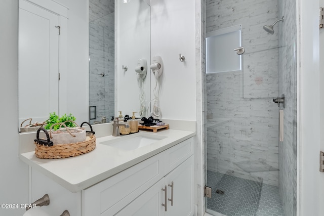 bathroom featuring vanity and a shower with shower door