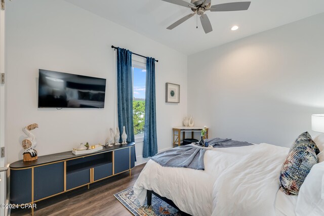 bedroom with ceiling fan and dark wood-type flooring