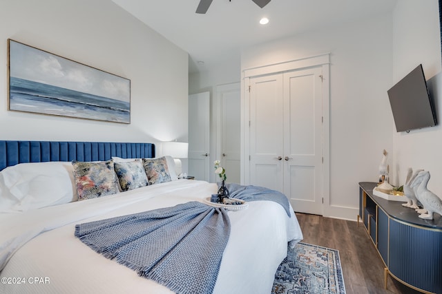 bedroom with dark hardwood / wood-style flooring, ceiling fan, and a closet