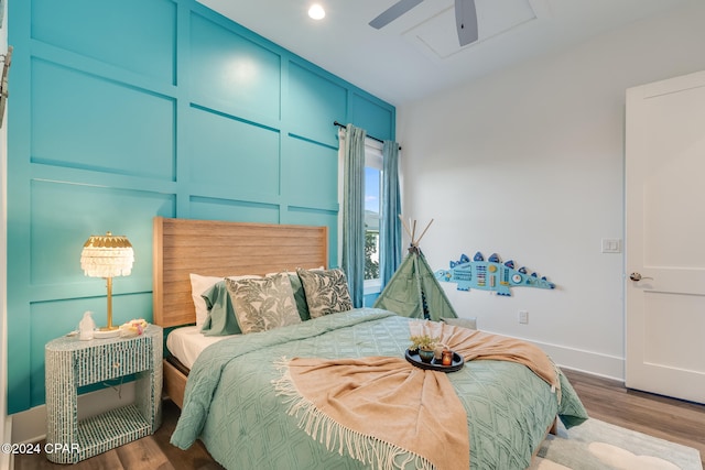 bedroom with light hardwood / wood-style flooring and ceiling fan