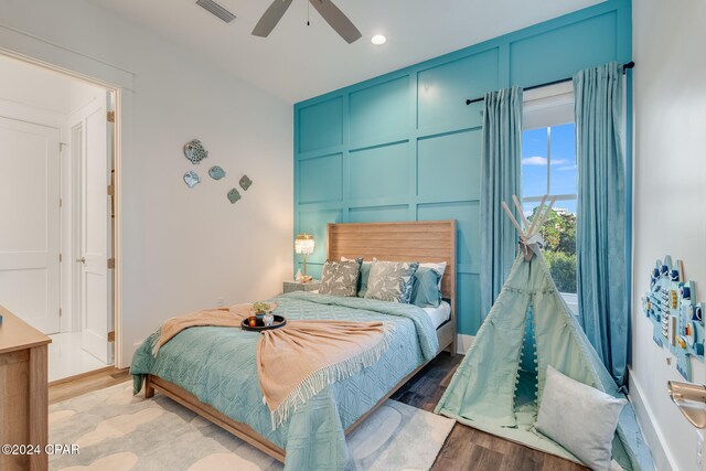 bedroom with light hardwood / wood-style flooring and ceiling fan