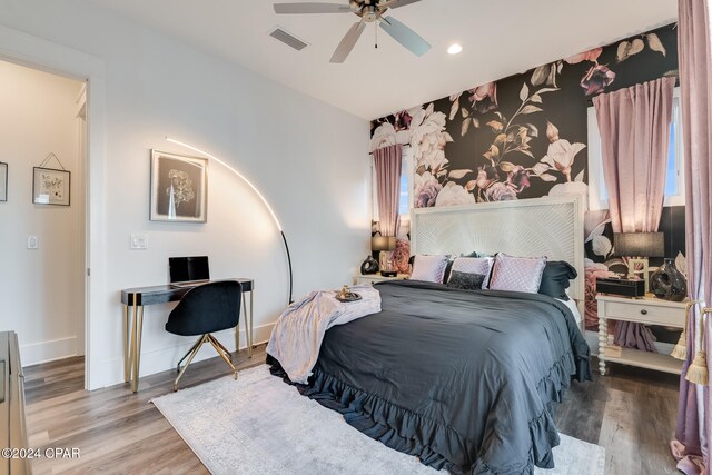 bedroom with ceiling fan and hardwood / wood-style floors