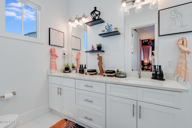 bathroom featuring tile patterned flooring, vanity, and toilet