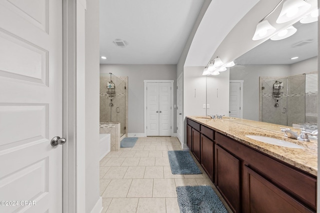 bathroom with plus walk in shower, tile patterned flooring, and vanity