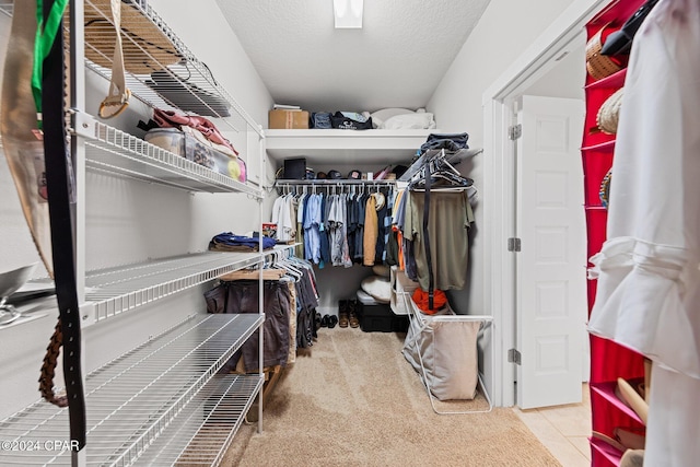 walk in closet featuring light tile patterned flooring