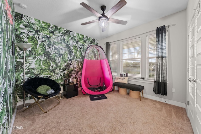 game room with carpet and ceiling fan