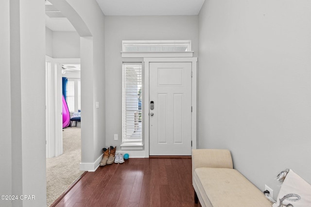 foyer featuring ceiling fan and dark wood-type flooring