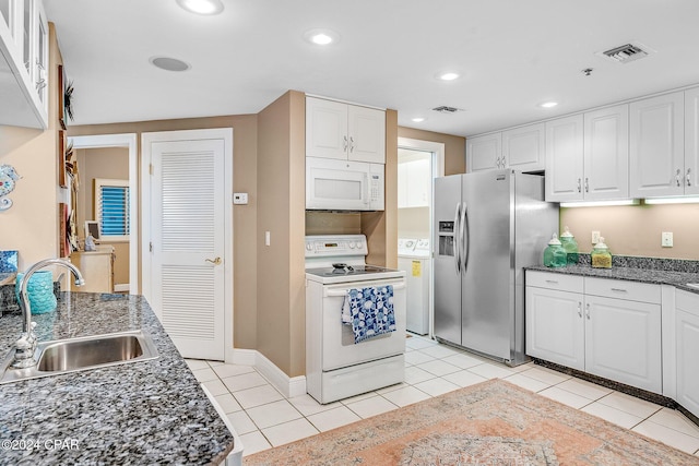 kitchen with white cabinets, light tile patterned floors, white appliances, and sink