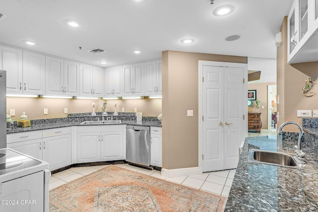 kitchen with white cabinets, light tile patterned flooring, stainless steel dishwasher, and sink