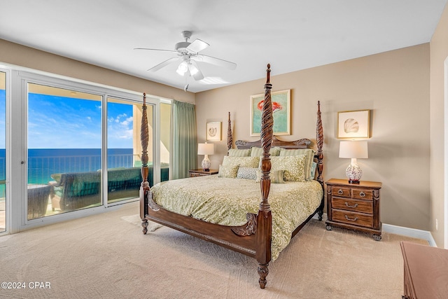 bedroom featuring access to exterior, ceiling fan, a water view, and light colored carpet