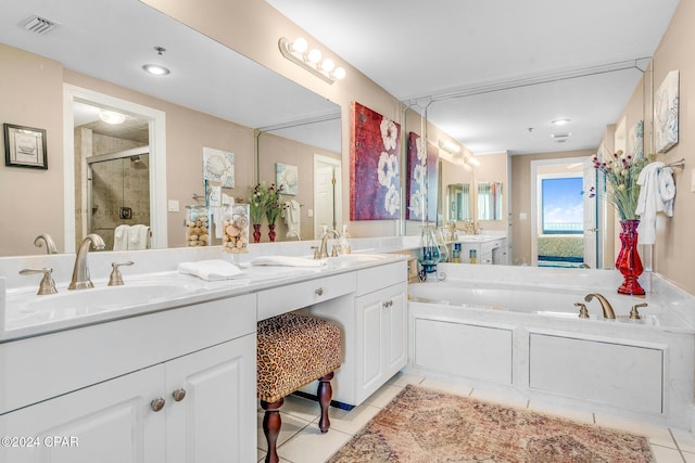 bathroom with plus walk in shower, vanity, and tile patterned flooring