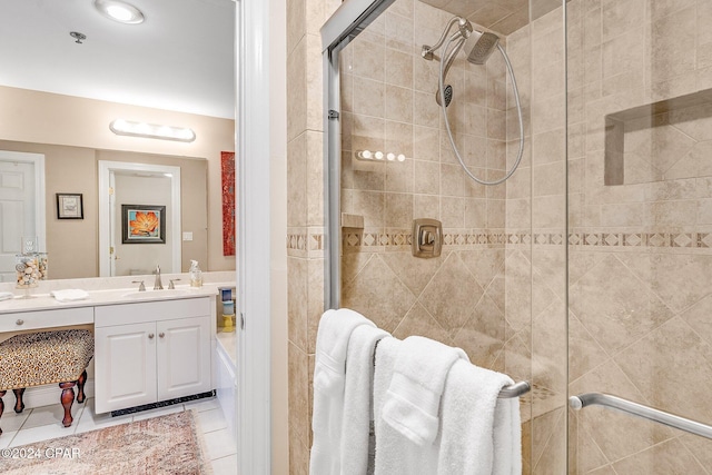 bathroom featuring tile patterned flooring, vanity, and walk in shower