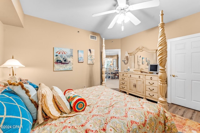 bedroom with ceiling fan and light hardwood / wood-style flooring