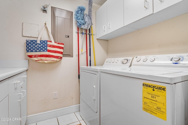 washroom featuring cabinets, electric panel, washer and clothes dryer, and light tile patterned flooring