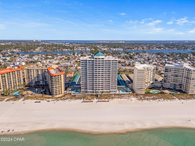 bird's eye view featuring a water view and a beach view