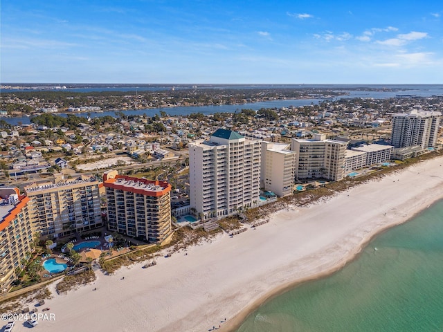 birds eye view of property featuring a beach view and a water view