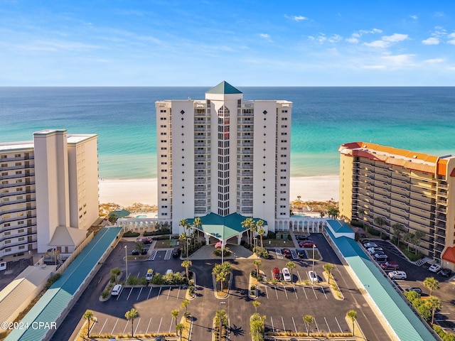 birds eye view of property featuring a water view and a beach view