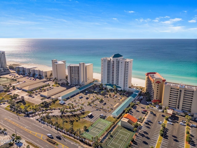 birds eye view of property featuring a water view and a beach view