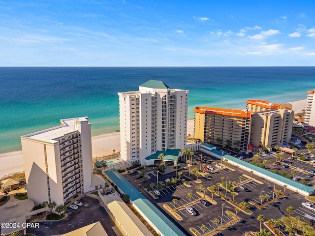 birds eye view of property featuring a water view and a beach view