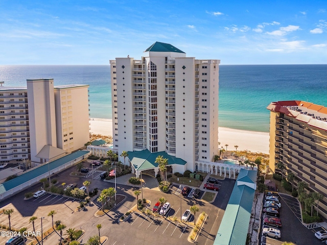 birds eye view of property featuring a water view and a view of the beach