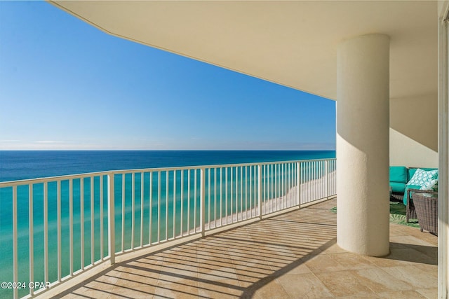 balcony featuring a water view and a beach view