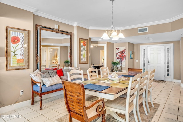 tiled dining space featuring an inviting chandelier and ornamental molding