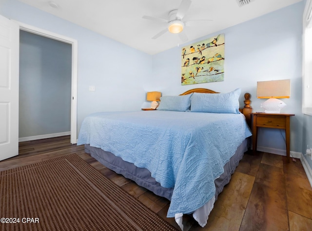 bedroom with baseboards, wood finished floors, and a ceiling fan