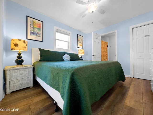 bedroom featuring a ceiling fan, wood finished floors, and baseboards