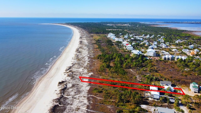 drone / aerial view featuring a water view and a view of the beach