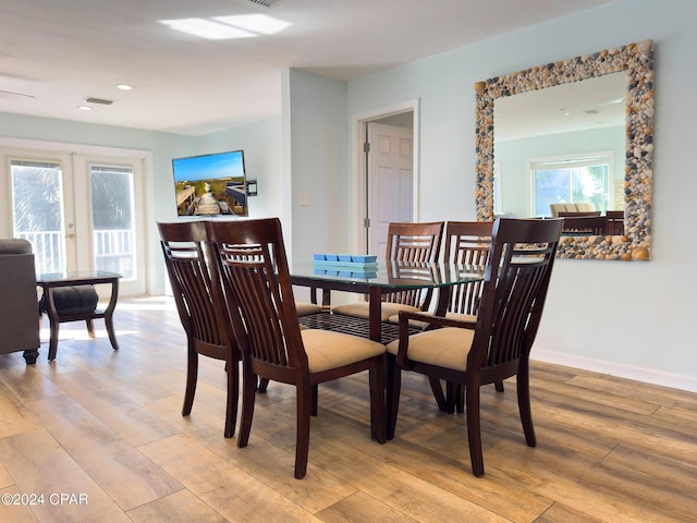 dining room with light wood finished floors, recessed lighting, and baseboards