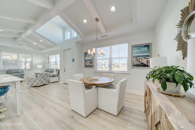 dining room featuring vaulted ceiling with beams, ceiling fan with notable chandelier, and light hardwood / wood-style floors