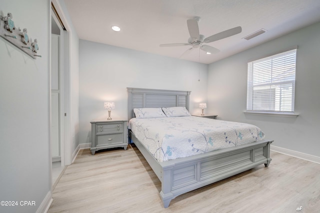 bedroom with ceiling fan and light wood-type flooring