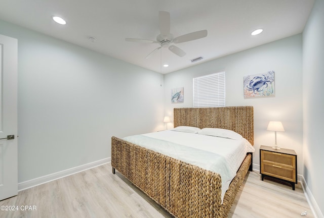 bedroom with ceiling fan and light hardwood / wood-style floors