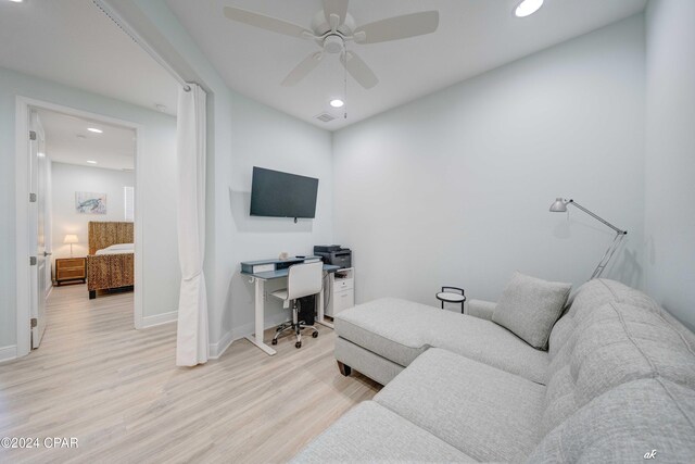 living room featuring ceiling fan and light wood-type flooring