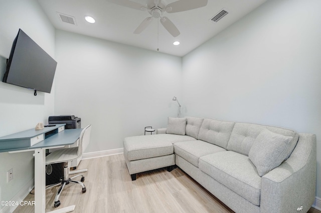 home office with ceiling fan and light hardwood / wood-style flooring