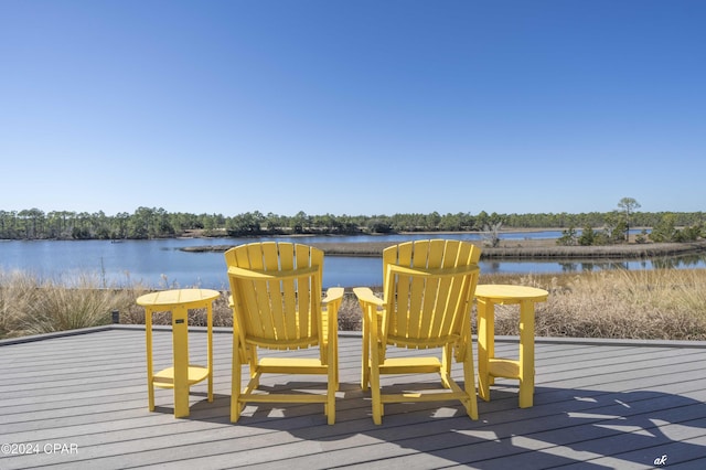 wooden terrace featuring a water view