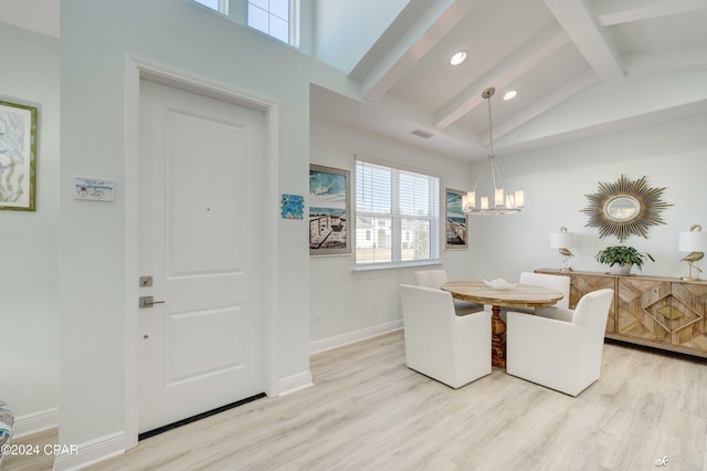 dining room featuring a chandelier, lofted ceiling with beams, and light hardwood / wood-style floors