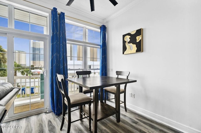 dining space with wood-type flooring, ceiling fan, and ornamental molding